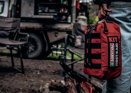 Person holding a survival first aid kit 