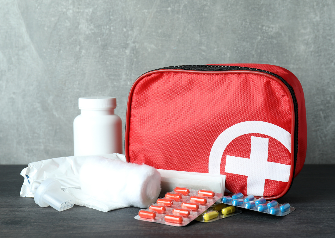 Red first aid kit with pills 