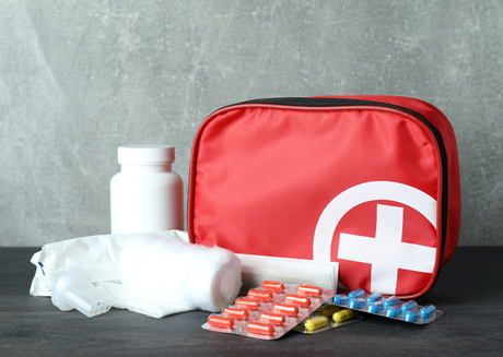 Red first aid kit with pills 