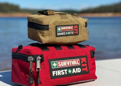 A red first aid kit and a smaller survival kit