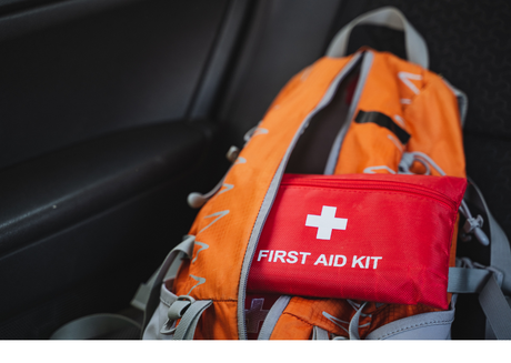 Orange backpack with red first aid kit