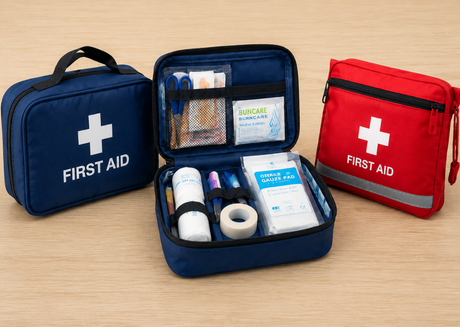 Red and blue first aid kits on table