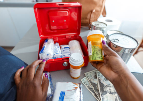 Prescription pills and medical supplies with cash on a table