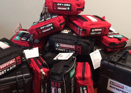 Stack of red survival first aid kits 