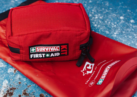 Red first aid kit on waterproof survival bag