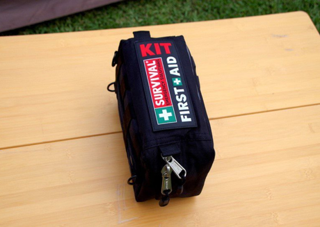 Survival first aid kit pouch on wooden surface