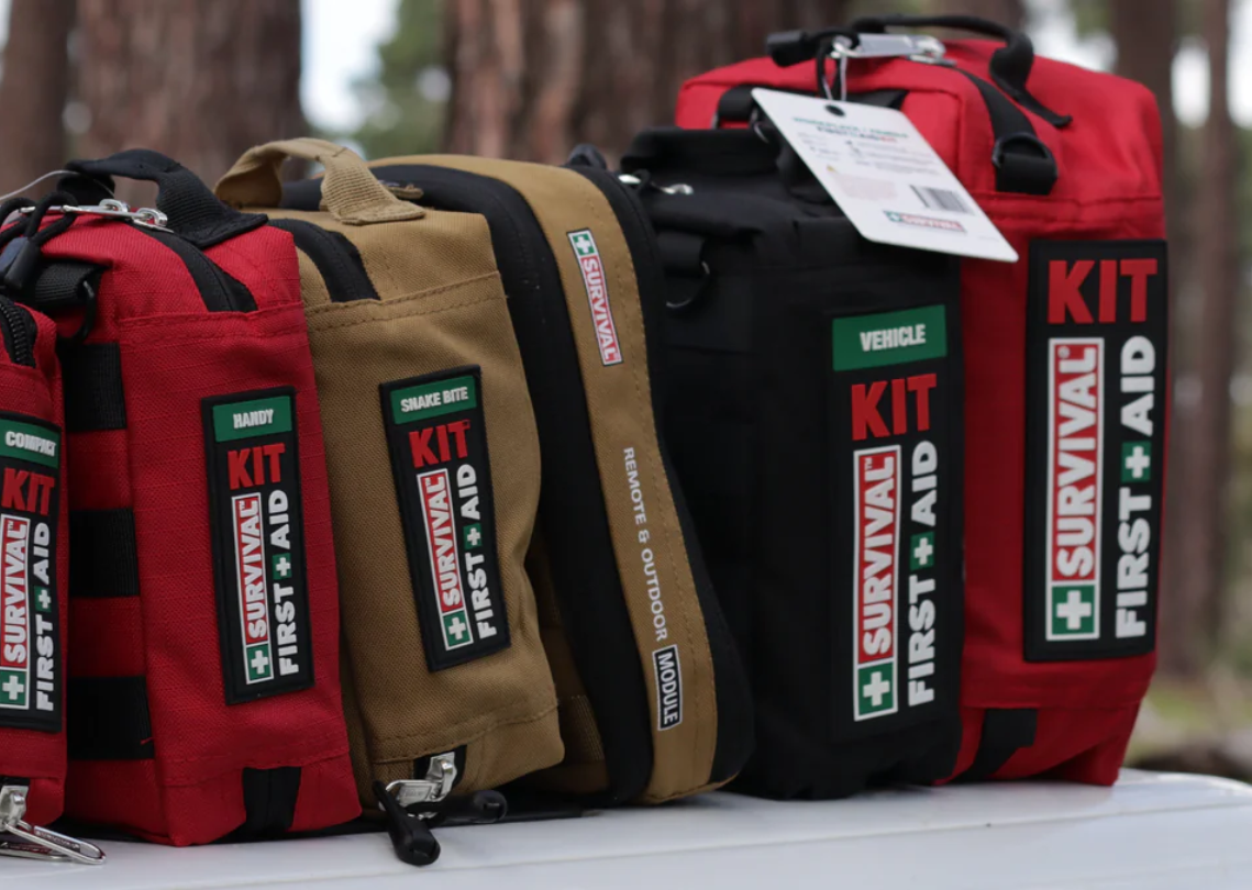 Outdoor display of survival first aid kits for different uses.