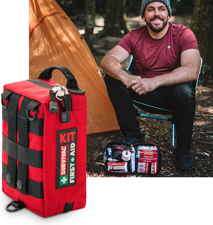 Man camping with SURVIVAL Handy First Aid KIT